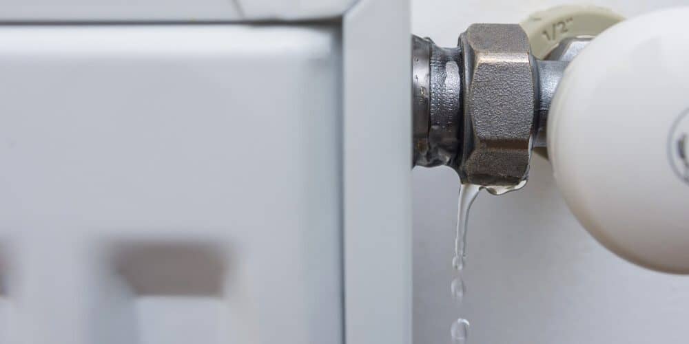 Leaking,Heating,Radiator.,Defective,Heater.,The,Need,For,Plumbing,Work
