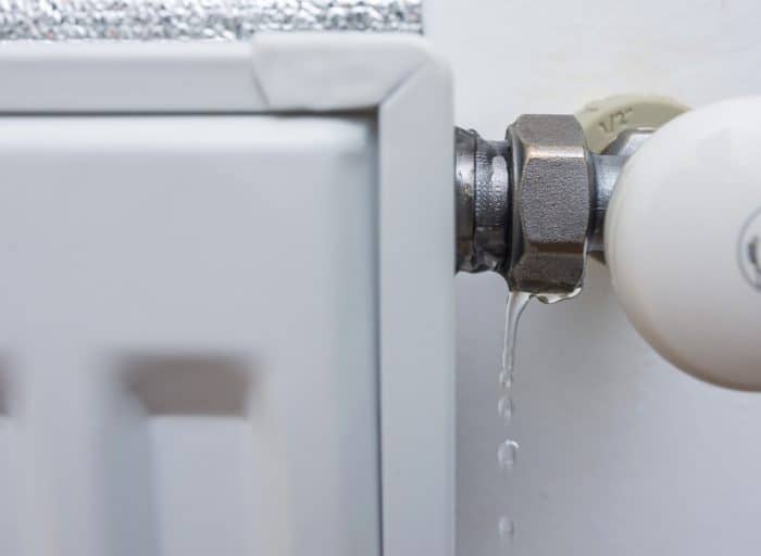 Leaking,Heating,Radiator.,Defective,Heater.,The,Need,For,Plumbing,Work